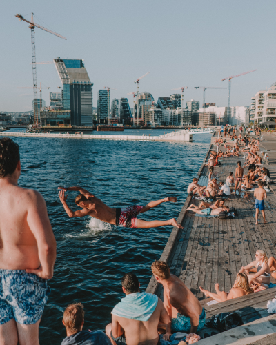 People playing and swimming at a bathing spot.